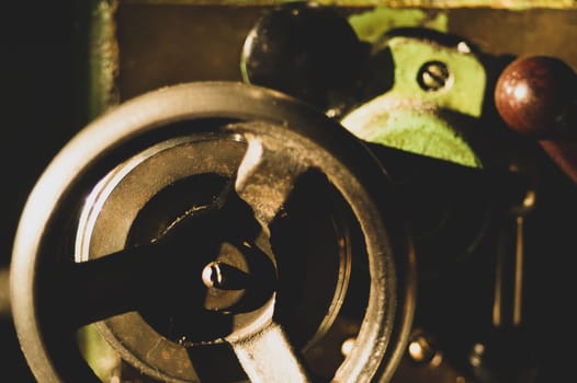Old lathe. detail of rusty machine. metal mechanism. vintage metalworking machine close up. abstract industrial background