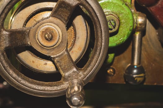 Old lathe. detail of rusty machine. metal mechanism. vintage metalworking machine close up. abstract industrial background