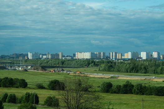 Urban cityscape panoramic view. horizon line with buildings. nature landscape with town and forest. blue sky. city into a distance
