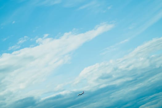 Airplane landing down. passenger aircraft with the blue cloudscape