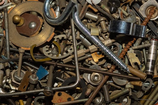 Old screws background. heap of tapping screws. work tool. pile of fasteners. bolts and nuts. metal scrap