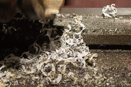 Twisted spiral steel shavings close up. drilling and lathe industry. metal engineering technology. metalworking process