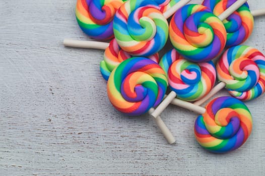 Lollipops on white wooden background. colorful candies close up. copy space
