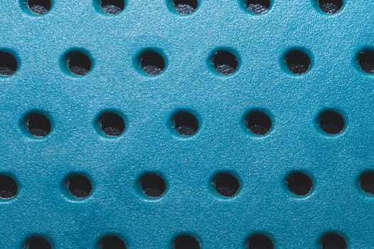 Holes in plastic surface. abstract pattern background