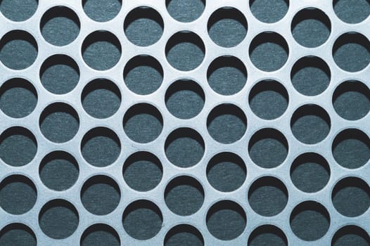 Steel plate with holes. metal grid with round cells. modern background. iron mesh