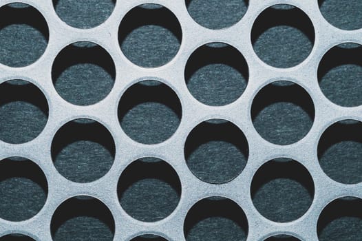 Steel plate with holes. metal grid with round cells. modern background. iron mesh