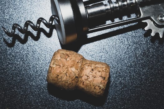Wine cork and corkscrew on the table close up