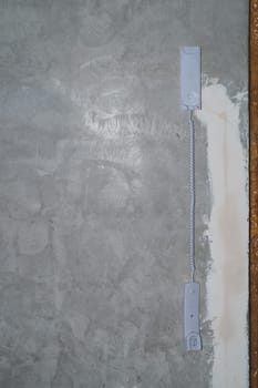Intercom phone receiver on gray concrete background. handset hanging on the wire close up