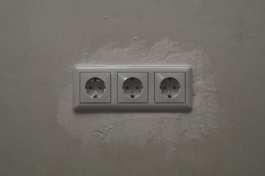 Power socket in the wall. electrical outlet close up. process of renovation