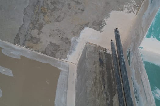 Corner between concrete wall and drywall. water pipes in the middle. interior construction. renovation process. abstract background
