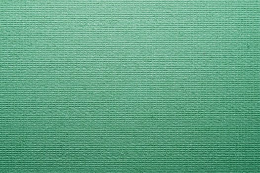 Green painted cardboard background close up