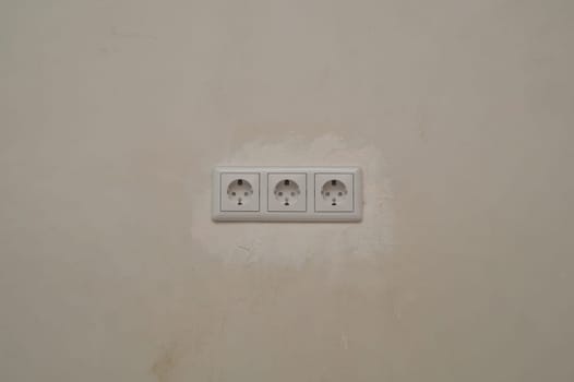 Power socket in the wall. electrical outlet close up. process of renovation