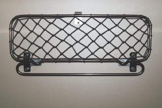 Wall clamp for things in the passenger train. frame with mesh
