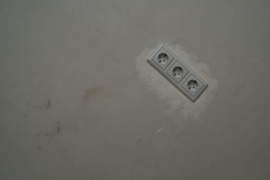 Power socket in the wall. electrical outlet close up. process of renovation