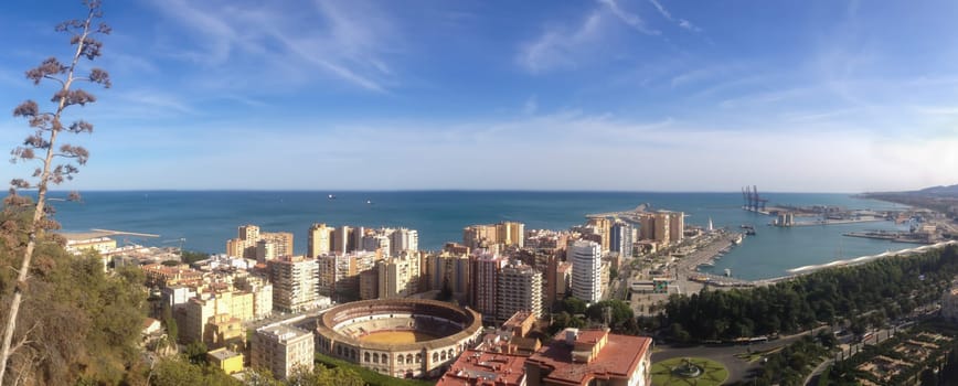 City by the shore of the sea. arena for a bull fights in the middle of buildings. beautiful nature landscape. Malaga, Spain