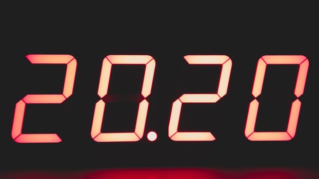 Digital clock with red led light illumination numbers 2020 in the dark. electronic timer