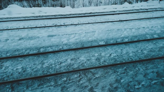 View on railroad track from the window of train. rails on the railway. winter weather
