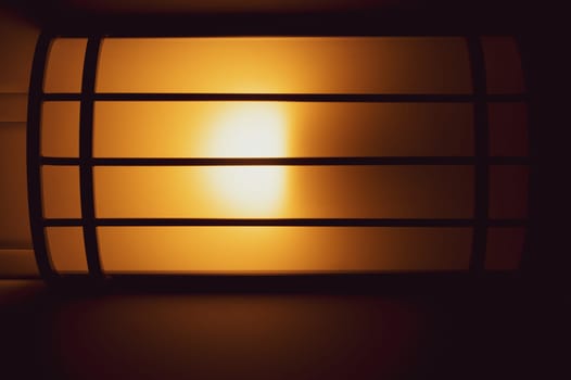 Lamp shines with warm light in the dark