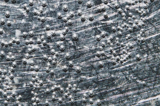 Boiling water bubbles close up. abstract texture with water drops on steel plate. gray rough background