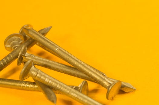Steel screw on a yellow background. working tools