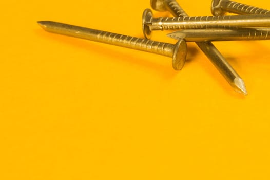 Steel screw on a yellow background. working tools