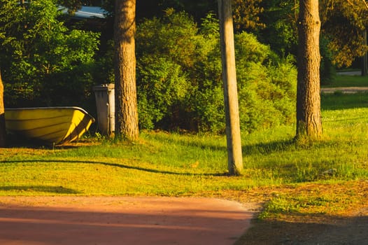 Yellow boat on the courtyard under the morning sunlight. fishing equipment