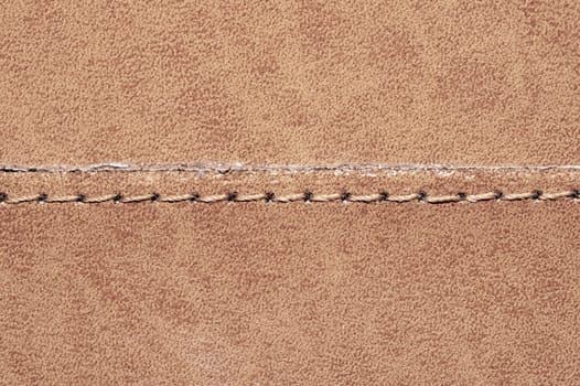 Brown leather texture with a linear stitch. material with seam