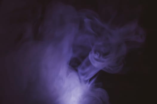 Violet smoke on black backdrop. color fog abstract background