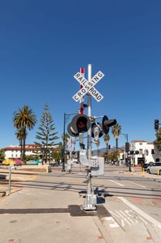 railroad crossing sign under clear blue sky