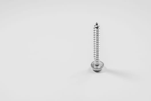 Steel screw on a white background. working tools