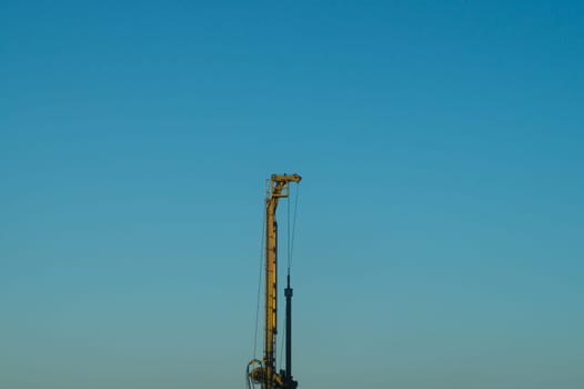 Industrial construction building crane city against a blue sky background