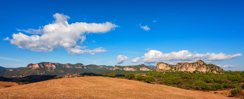 Beautiful blue sky with clouds over the limestone formations of Ogliastra, Sardinian dolomite formations. Nature of an unspoiled landscape.