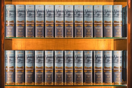 Bushmills, Northern Ireland, Aug 2019 Rows of aged 12 years Bushmills whiskey in a boxes, on illuminated display in distillery shop