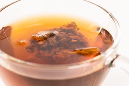 Aromatic hot herbal tea in a glass cup
