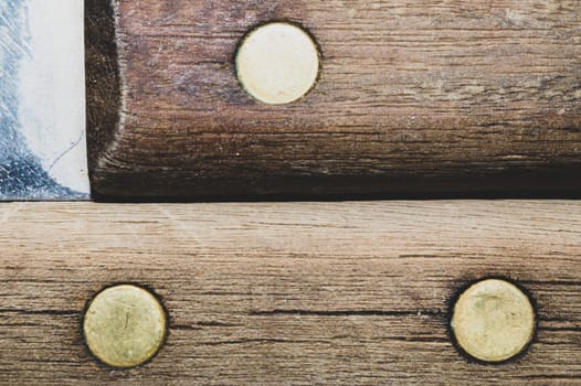 Old wooden background with dowels. wood texture with a metal pins