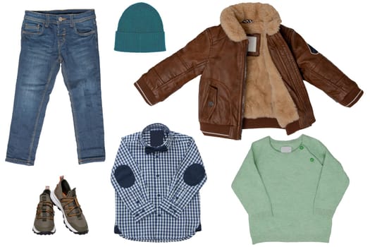 Collage set of little boy autumn clothing isolated on a white background. Denim trouseror jeans, a pair shoes, a leather jacket and pullover or sweatershirt and hood for child boy. Kids winter fashion.
