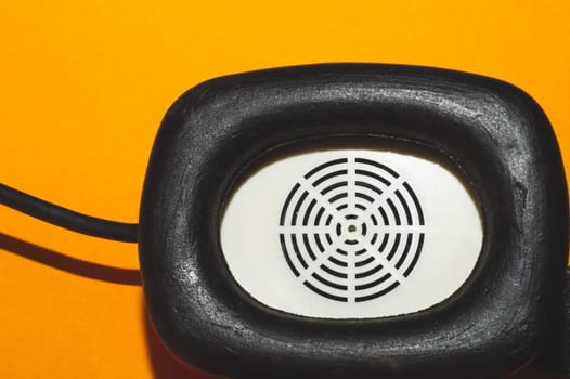 Vintage red headphones on yellow background. retro earphones