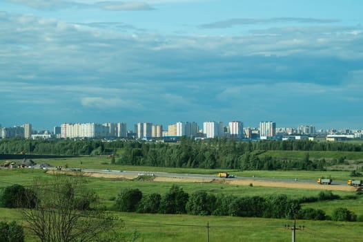 Urban cityscape panoramic view. horizon line with buildings. nature landscape with town and forest. blue sky. city into a distance