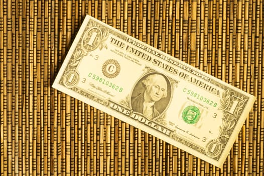 One dollar on a wooden bamboo background. money on the table. finance background