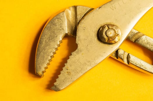 Pipe wrench on yellow background. adjustable gas wrench. instrument for repair. working tool