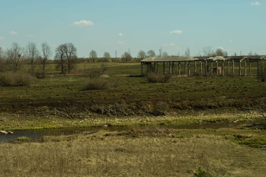Old abandoned building in the forest. ruined cowshed. rural landscape