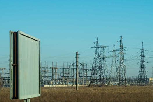 Power line posts. high voltage tower with the sky. industrial background. empty billboard. mockup