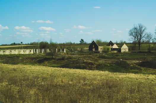 Old abandoned building in the forest. ruined cowshed. rural landscape