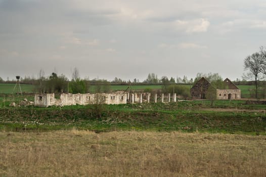 Old abandoned building in the forest. ruined cowshed. rural landscape
