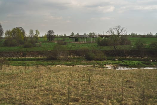 Old abandoned building in the forest. ruined cowshed. rural landscape