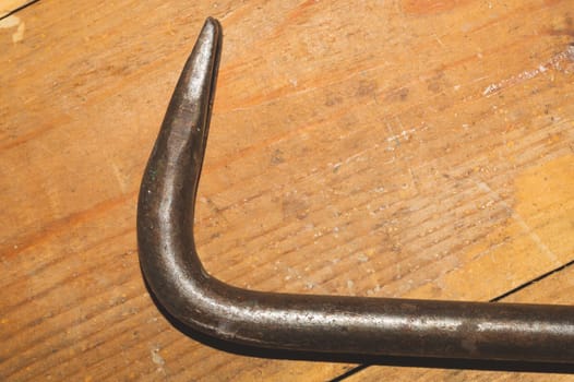 Nail puller on a wooden table. working tool. carpentry instrument