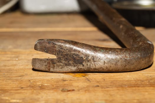 Nail puller on a wooden table. working tool. carpentry instrument