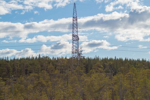 Power line post in forest. high voltage tower with the sky. industrial background
