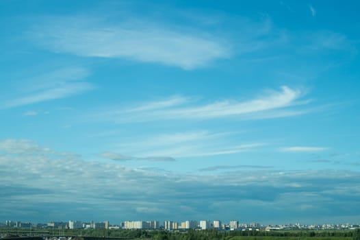 Urban cityscape panoramic view. horizon line with buildings. nature landscape with town and forest. blue sky. city into a distance
