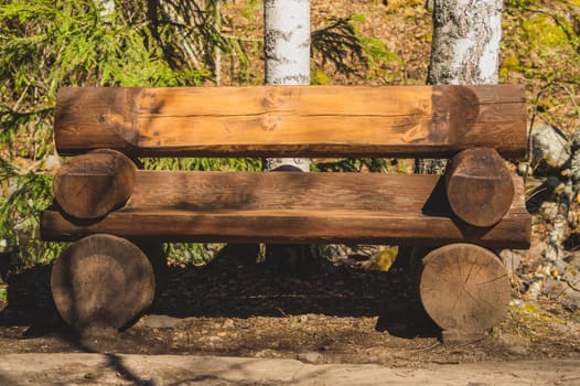 Wooden log bench in the forest. park decor